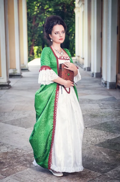 Beautiful woman in medieval dress with book — Stock Photo, Image