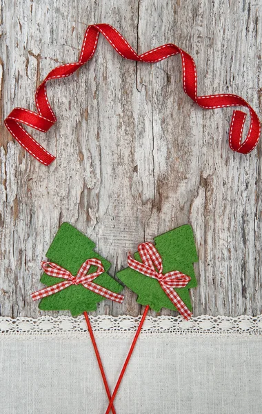 Two green fir tree with ribbon on the old wood background — Stock Photo, Image