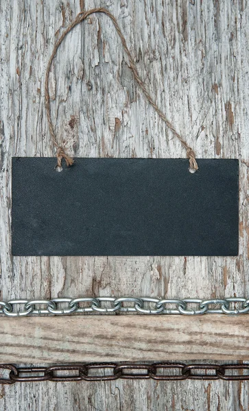 Chalkboard with metal chain on the old wood — Stock Photo, Image