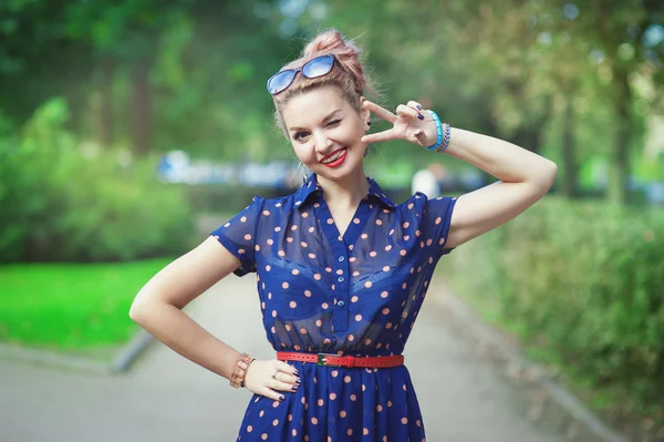 Beautiful woman in fifties style with braces winking — Stock Photo, Image