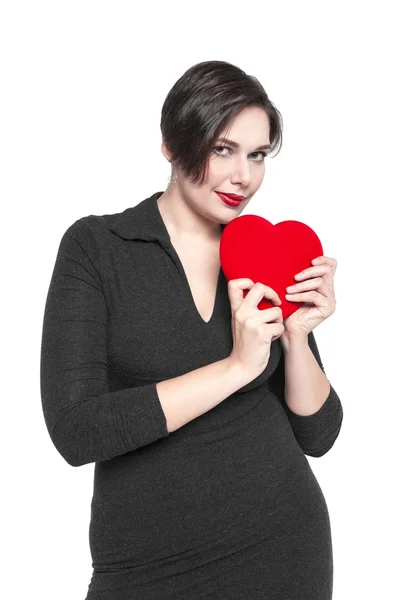 Beautiful plus size woman with red heart isolated — Stock Photo, Image