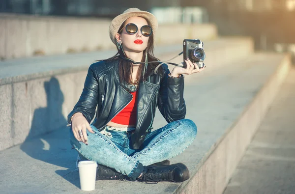 Young fashion beautiful girl in leather jacket with retro camera — Stock Photo, Image