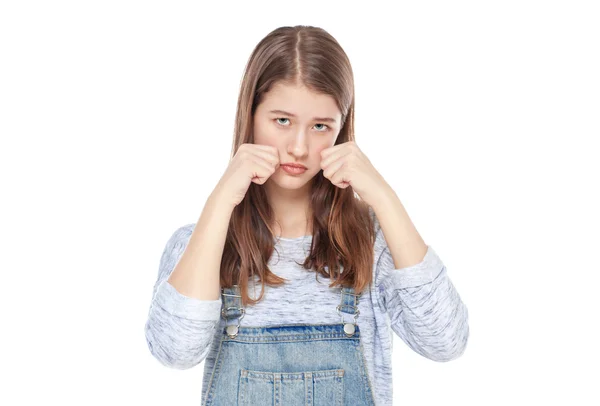 Sad young fashion girl in jeans overalls isolated — Stock Photo, Image