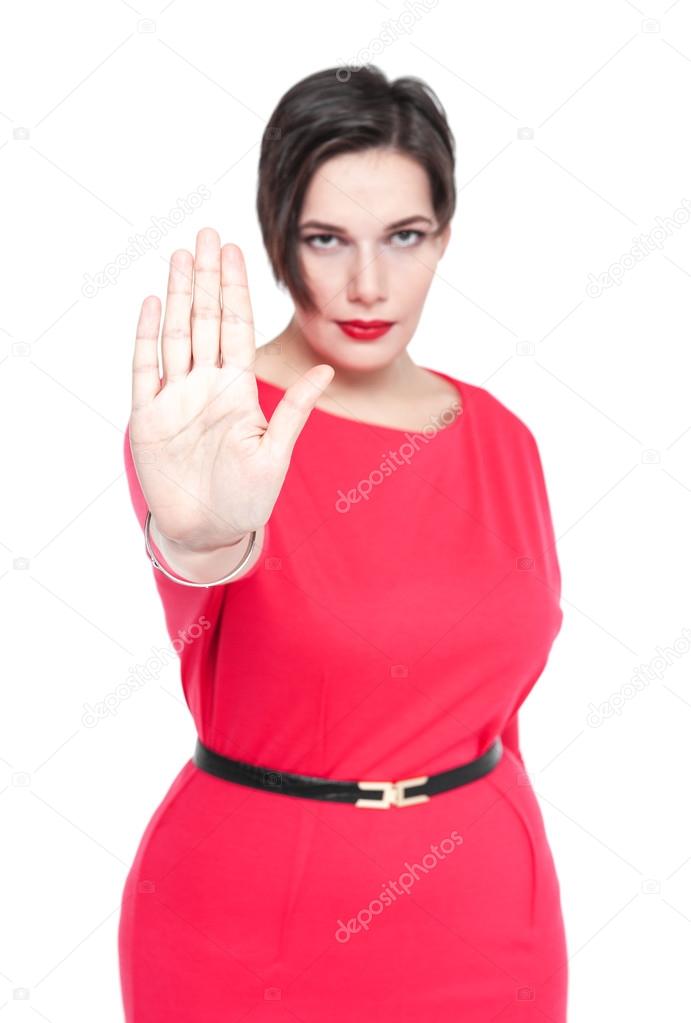 Beautiful plus size woman making stop sign gesture isolated. Foc