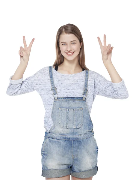 Happy young teenager girl showing victory gesture isolated — Stock Photo, Image