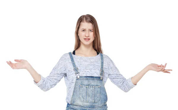 Annoyed young fashion girl in jeans overalls isolated — Stock Photo, Image