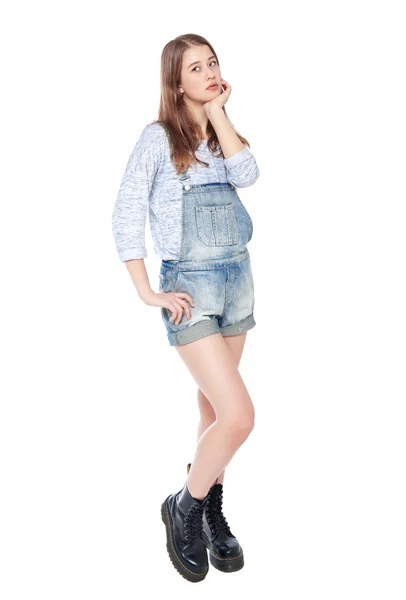 Young fashion girl in jeans overalls posing isolated — Stock Photo, Image