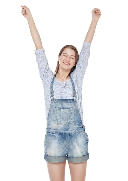 Szczęśliwy moda młoda dziewczyna w dżinsy kombinezon z rąk się izolat — Zdjęcie stockowe