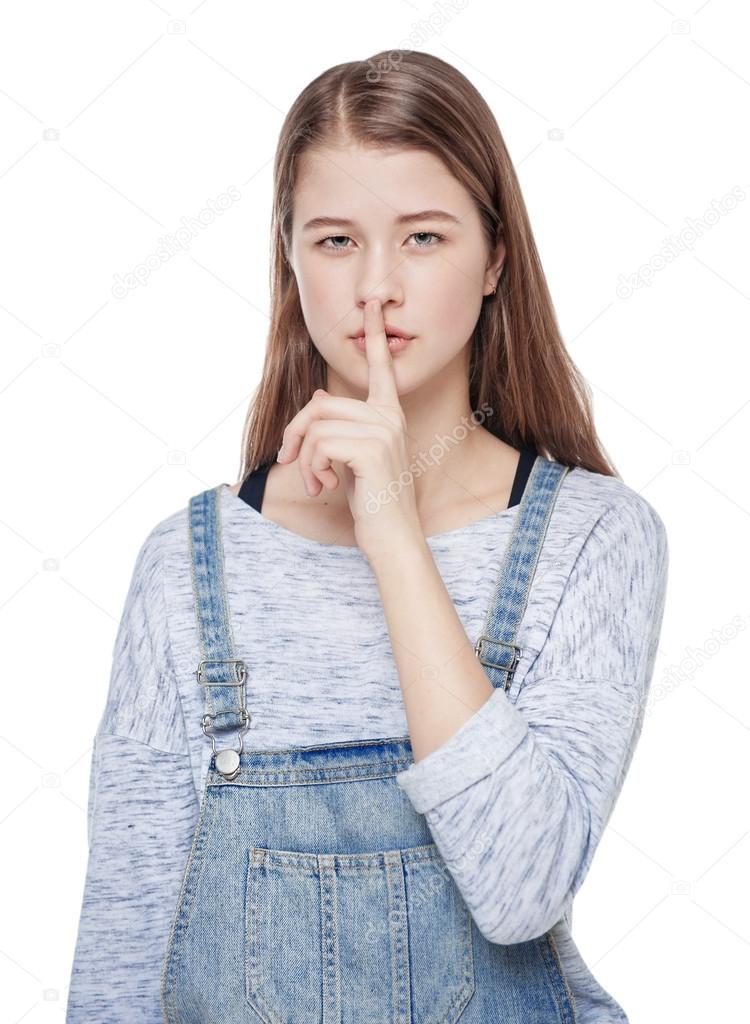 Young fashion girl with finger on lips isolated