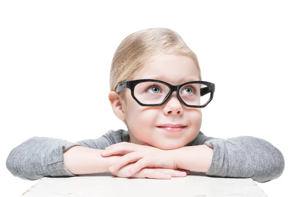 Smart beautiful little girl in glasses looking on something — Stock Photo, Image