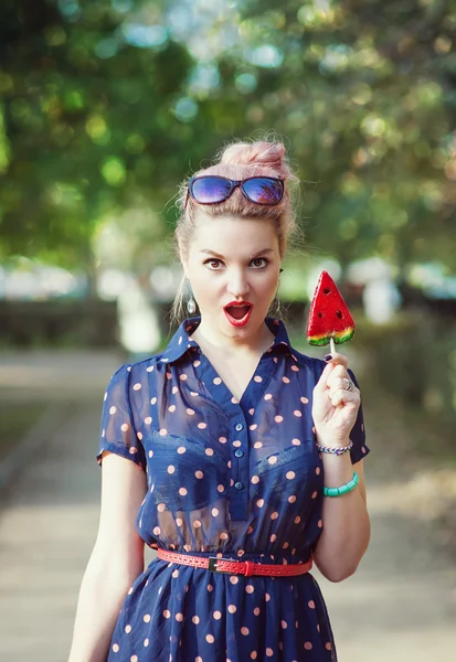 Beautiful young woman in fifties style with candy — Stock Photo, Image