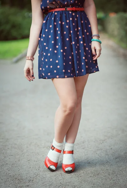 Red sandals with white socks on girl legs in fifties style — Stock Photo, Image