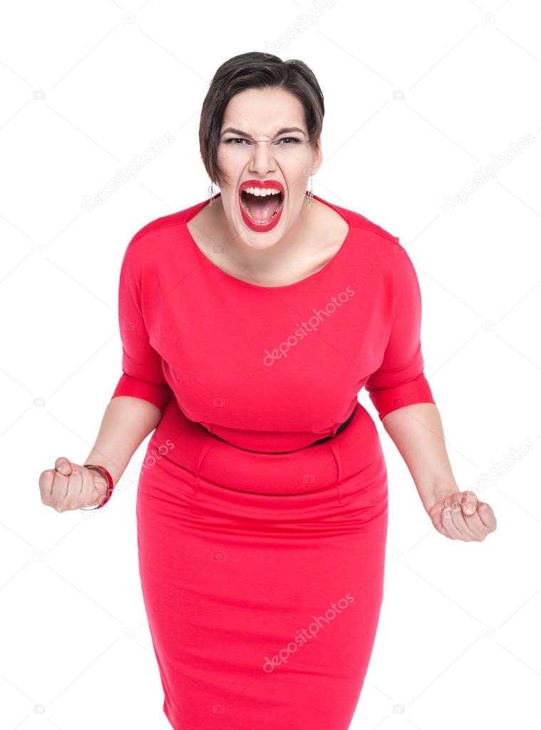 Angry screaming beautiful plus size woman in red dress isolated 