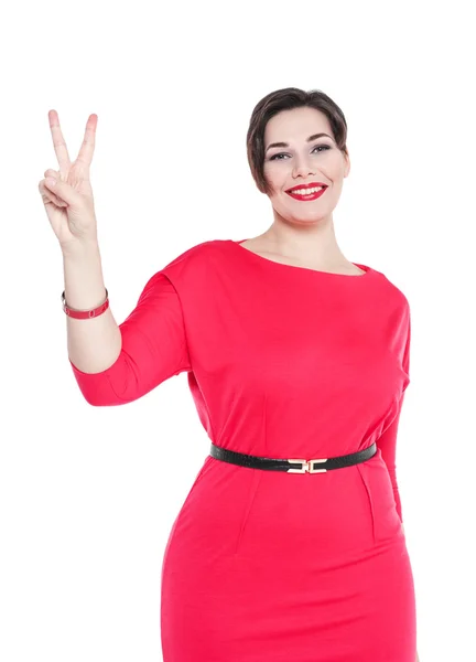 Beautiful plus size woman in red dress with victory isolated — Stock Photo, Image