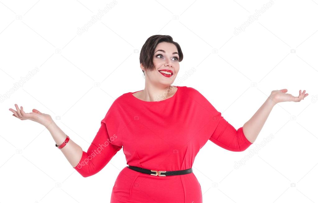 Beautiful plus size woman in red dress shrugs her shoulders 