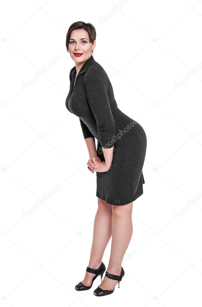 Beautiful plus size woman in black dress posing isolated 