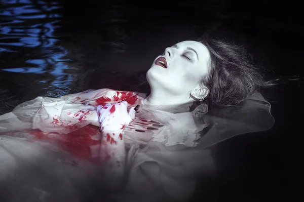 Young beautiful drowned woman in bloody dress — Stock Photo, Image