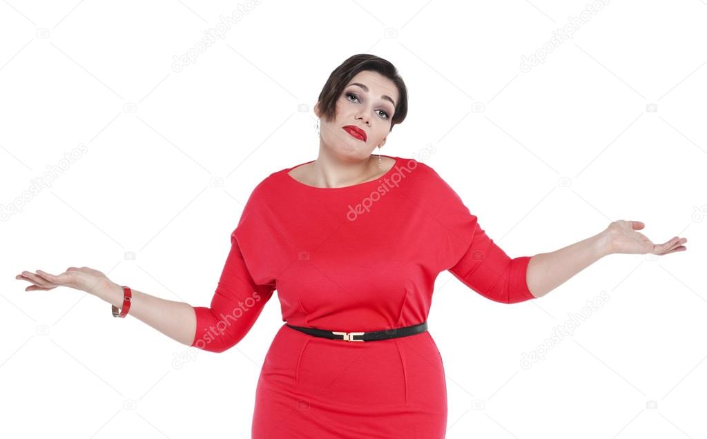 Beautiful plus size woman in red dress shrugs her shoulders 