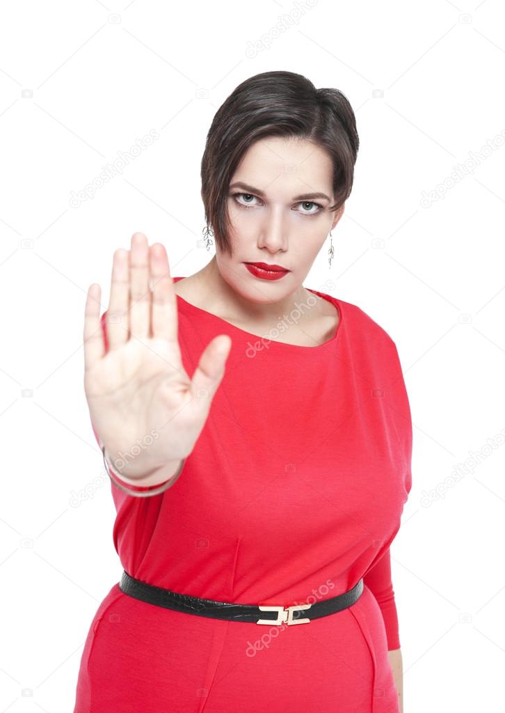 Beautiful plus size woman in red dress making stop sign gesture