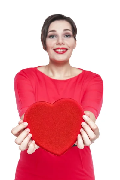Beautiful plus size woman with red heart. Focus on heart — Stock Photo, Image