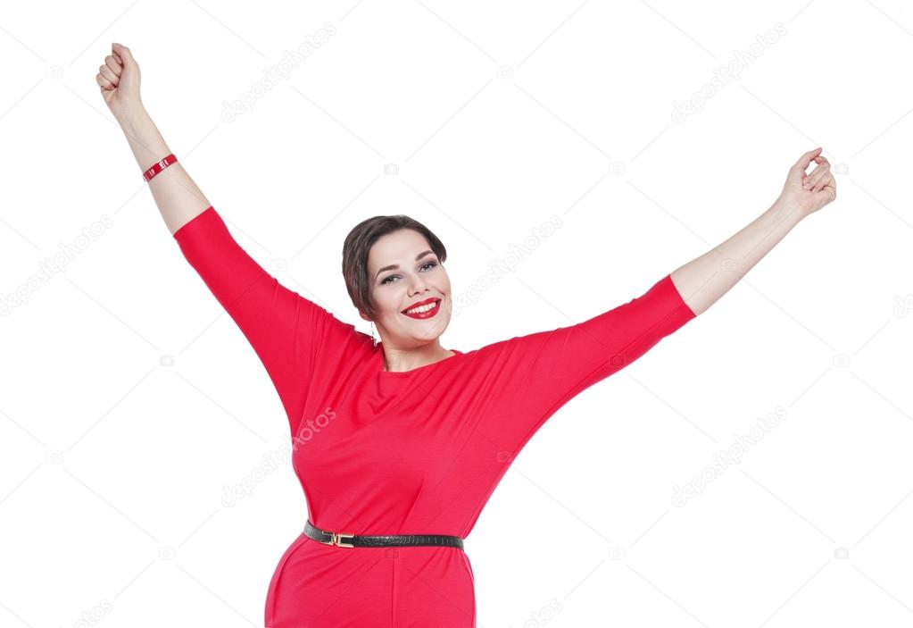 Happy beautiful plus size woman in red dress with hands up isola