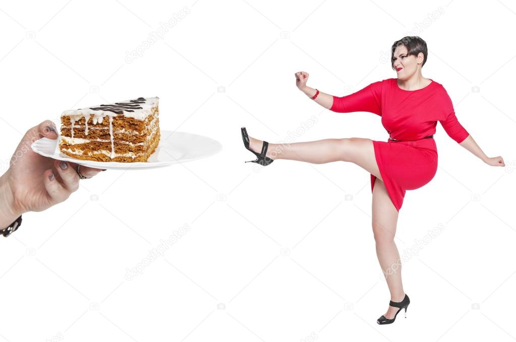 Beautiful plus size woman fighting off unhealthy food isolated 