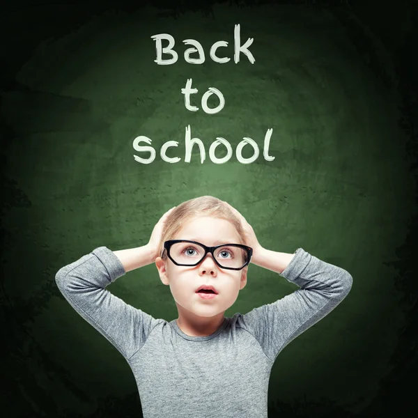 Excited beautiful little girl on the chalkboard background — Stock Photo, Image