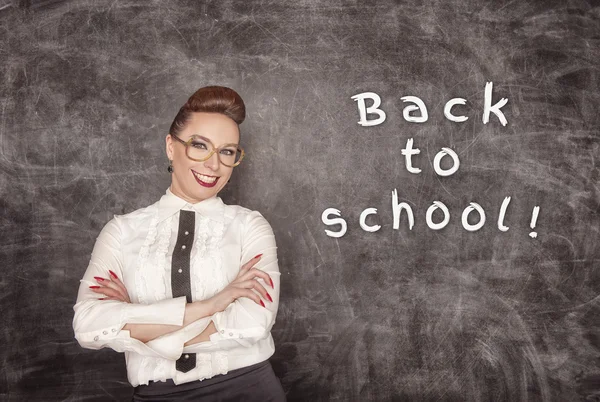 Happy teacher on the school blackboard background — Stock Photo, Image