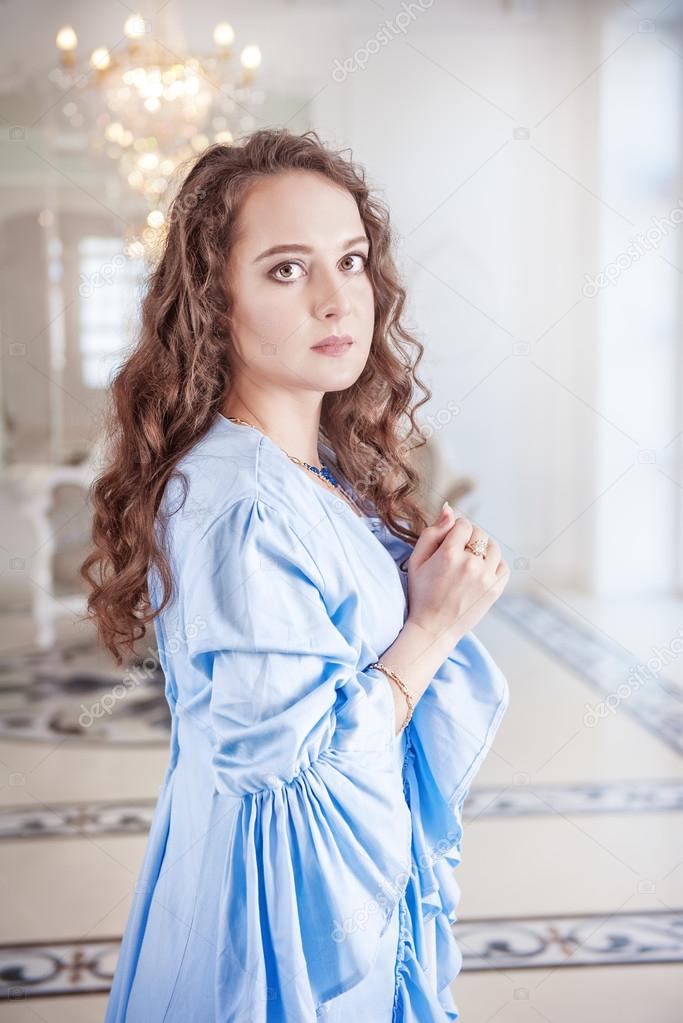 Beautiful young woman in blue dressing gown 