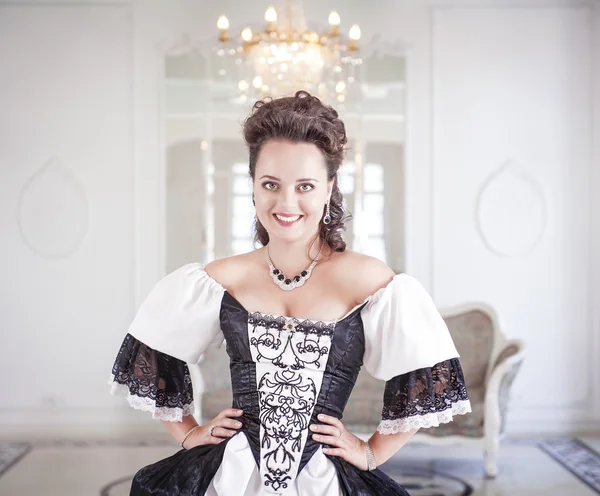 Beautiful young woman in long medieval dress — Stock Photo, Image