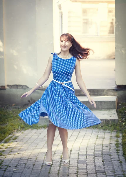 Beautiful woman in retro style dress whirl — Stock Photo, Image