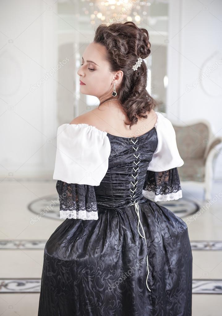 Beautiful medieval woman in black and white dress