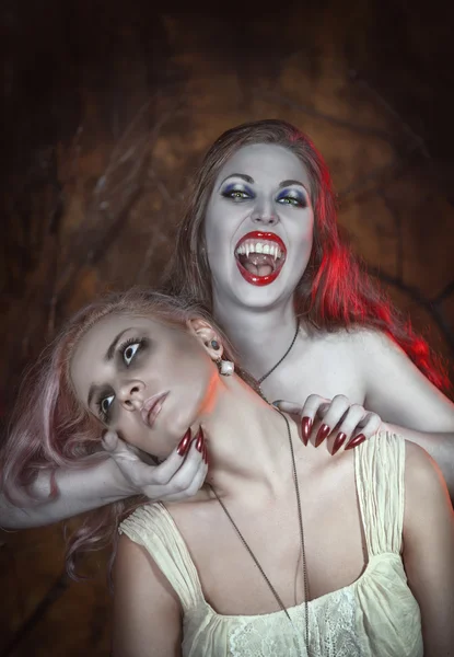 Beautiful vampire woman and her victim — Stock Photo, Image