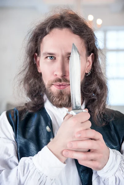 Handsome man in medieval clothes with dagger — Stock Photo, Image