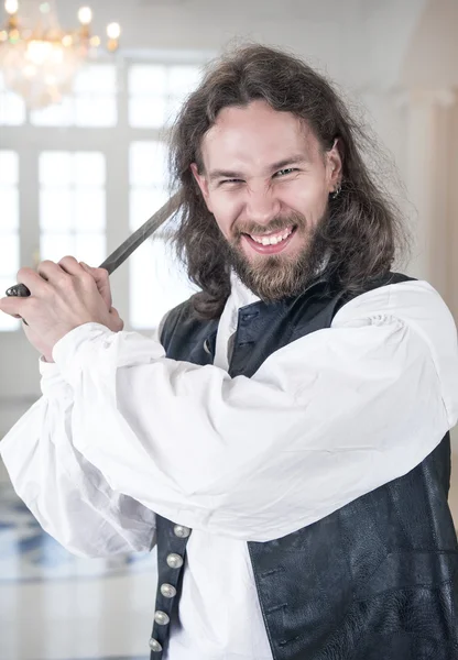 Handsome man in medieval clothes threaten with sword — Stock Photo, Image