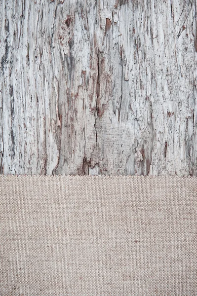 Old wooden background with burlap jute canvas — Stock Photo, Image