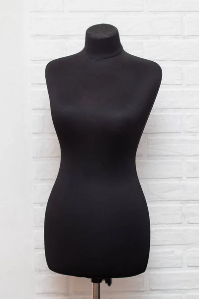 Professional black women tailor sewing mannequin.