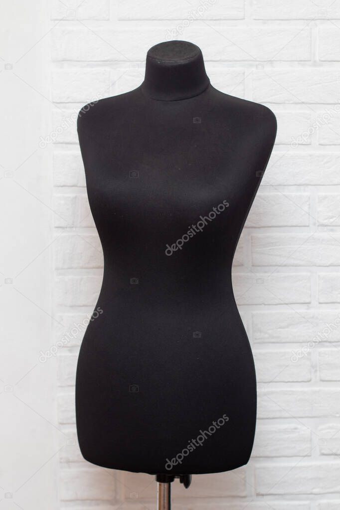 Professional black women tailor sewing mannequin.