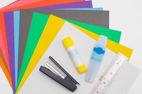 Set of colored cardboard for cutting. Stapler, glue stick, colored markers and ruler — Stock Photo, Image