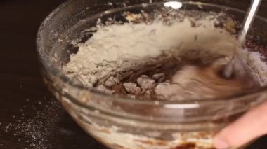 Karıştırıcı, cam kasede kek için çikolatalı hamurla unu karıştırıyor. Dişi, kek yapıyor. Adım adım test tarifi