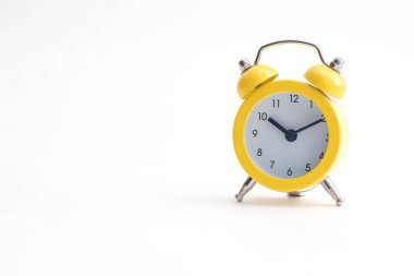 Yellow alarm clock with bell isolated on white background.