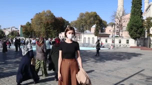 Une jeune femme portant un masque médical devant Hagia Sophia à Istanbul — Video