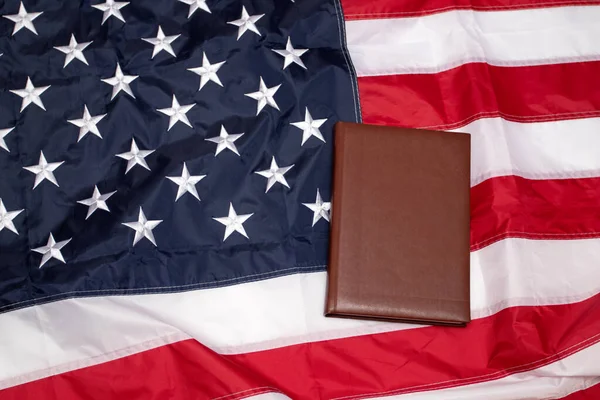 American Flag with brown blank book. Flag of the USA. Memorial Day. Independence Day 4th of July.