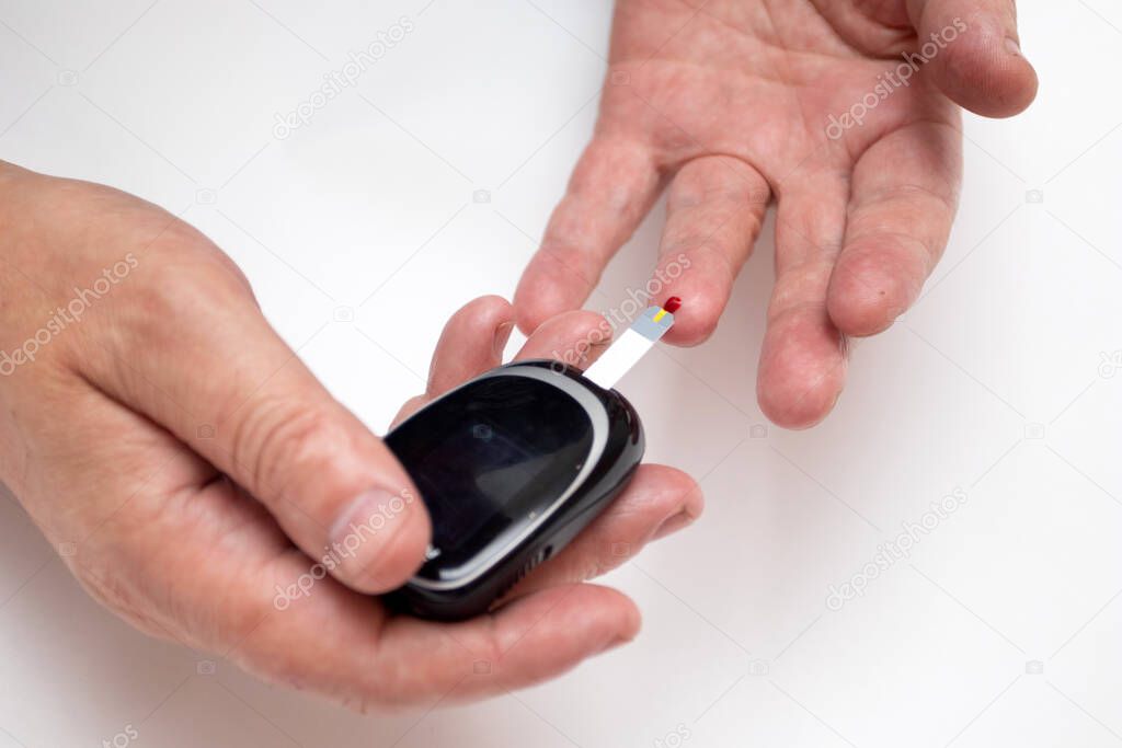 Man Checking Blood Sugar Level with Glucometer
