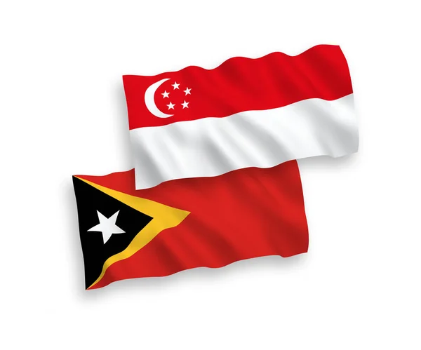 Nationell Vektor Tyg Våg Flaggor Östtimor Och Singapore Isolerad Vit — Stock vektor