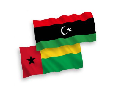 Beyaz arka planda Gine Bissau ve Libya Cumhuriyeti 'nin ulusal taşıyıcı kumaş bayrakları izole edildi. 1 'e 2 oranında.