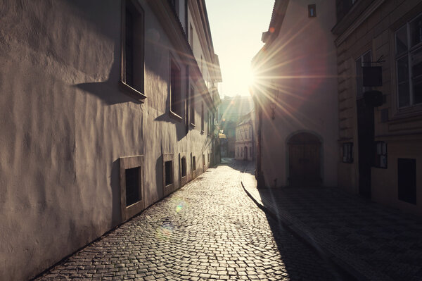Old street in Prague at morning sunlight. Vintage filter