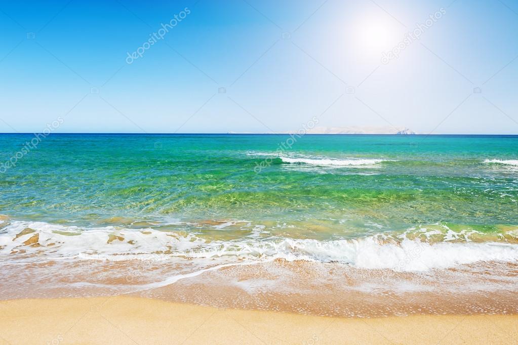 Tropical beach with turquoise water and white sand.