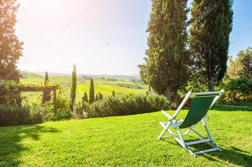 Deck chair on the green meadow
