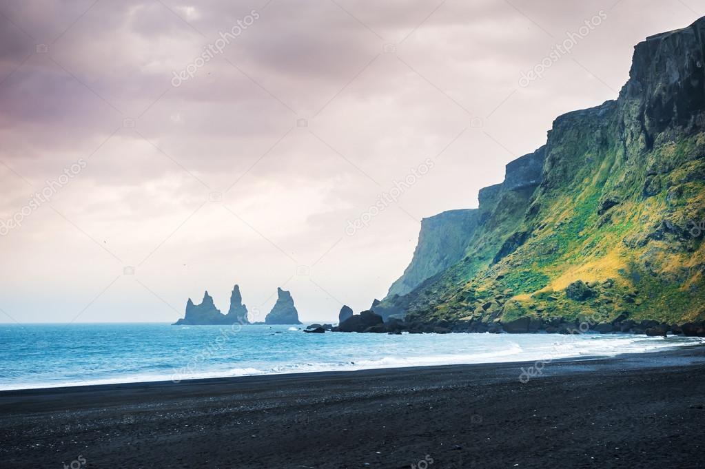 Famous Reynisdrangar rock formations and the mount Reynisfjall.